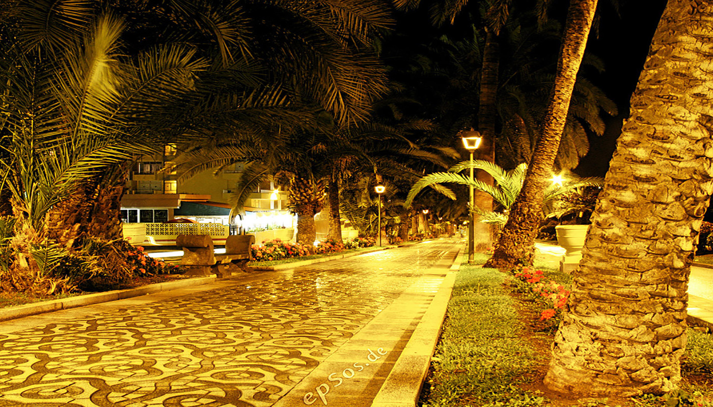 This warmly illuminated picture of city streets at night was photographed in the tropical town center of Puerto Cruz de Tenerife. 